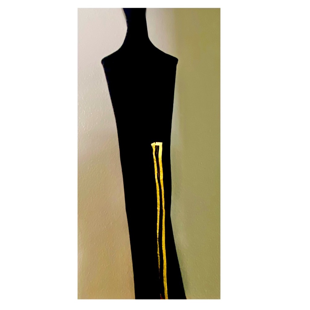 Black dress with a gold zipper split